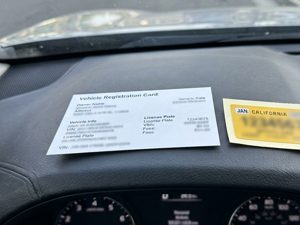 Renewed registration card photographed on the dashboard